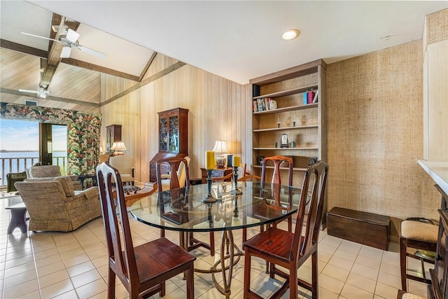 tiled dining area featuring ceiling fan, vaulted ceiling with beams, and built in features