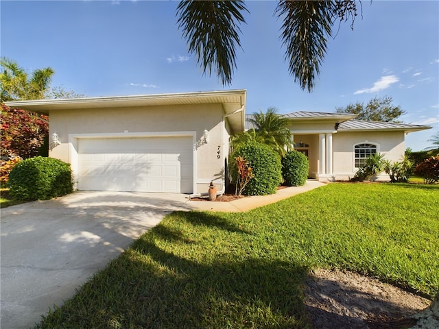 view of front of house with a garage and a front yard