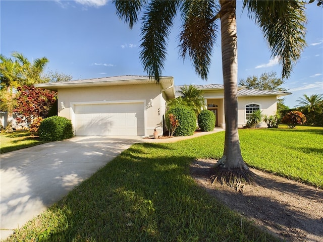 single story home with a garage and a front lawn