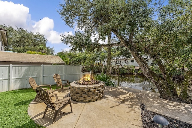 view of patio featuring a water view and an outdoor fire pit