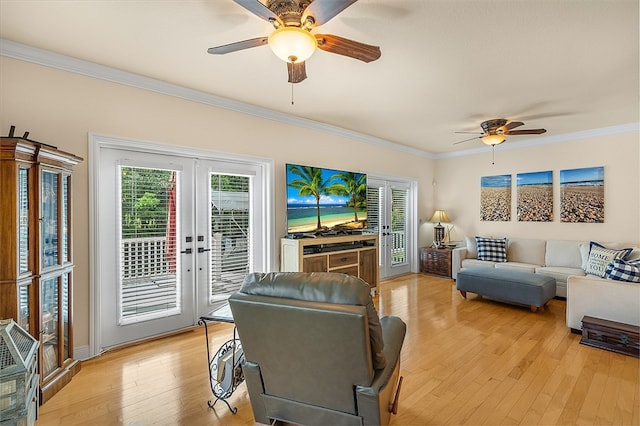 living room with french doors, a wealth of natural light, and light hardwood / wood-style flooring