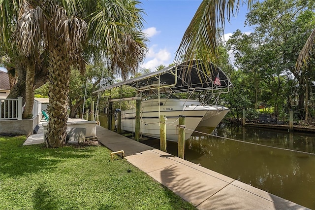 dock area with a lawn and a water view