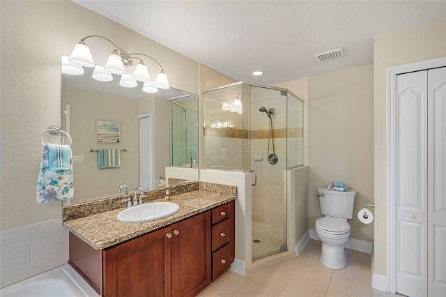 bathroom with toilet, tile patterned flooring, walk in shower, and vanity