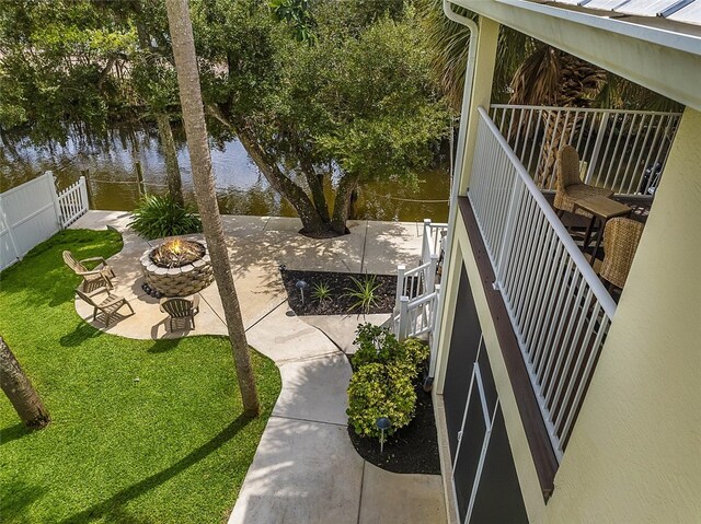 view of yard with a patio area, a water view, and a fire pit