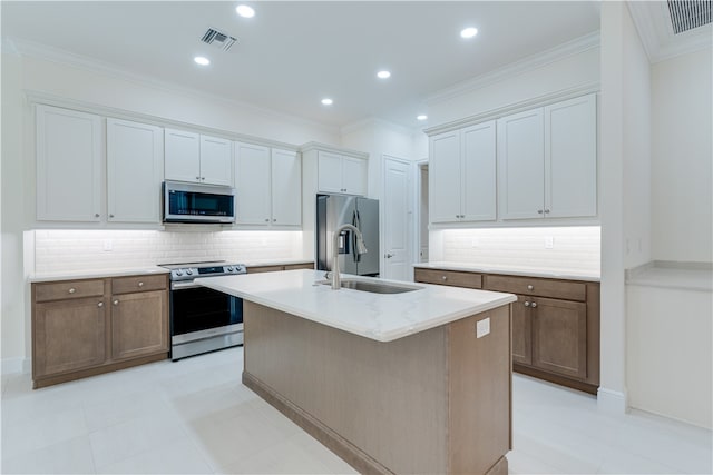 kitchen with stainless steel appliances, backsplash, light tile patterned floors, sink, and a kitchen island with sink