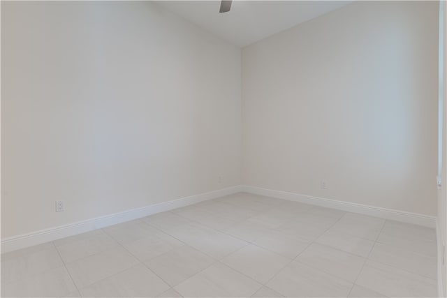 empty room featuring ceiling fan and light tile patterned floors