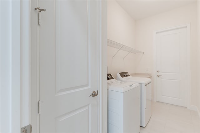 clothes washing area with washer and clothes dryer