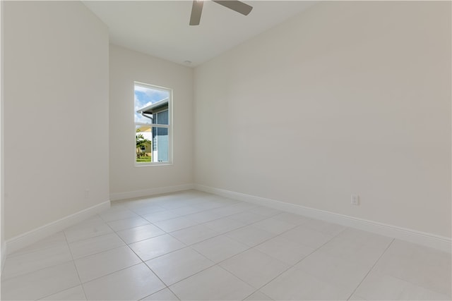 spare room with ceiling fan and light tile patterned floors