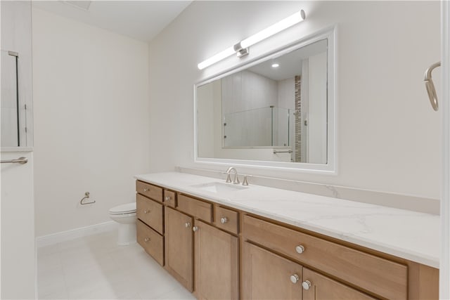 bathroom with toilet, vanity, and an enclosed shower