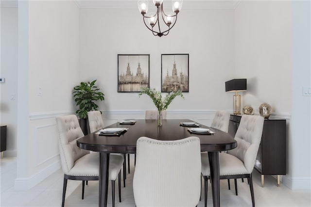 tiled dining room with a notable chandelier and ornamental molding