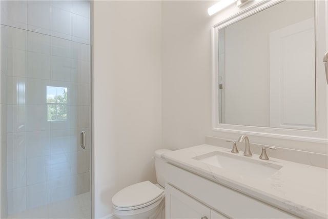 bathroom with walk in shower, vanity, and toilet