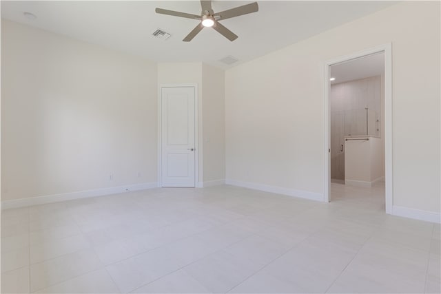 spare room with light tile patterned floors and ceiling fan