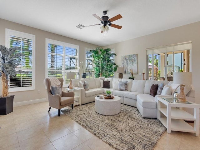 2785 Grand Isle Way SW, Vero Beach, FL 32968 - living area with healthy amount of natural light, ceiling fan, light tile patterned floors, and baseboards