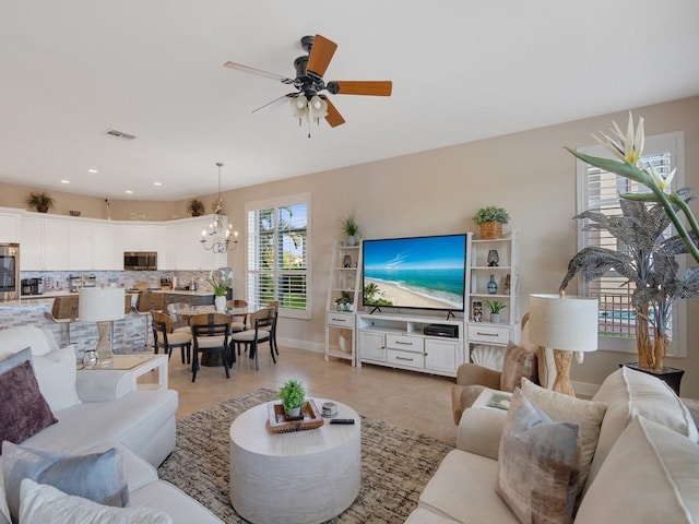 2785 Grand Isle Way SW, Vero Beach, FL 32968 - living room featuring baseboards, a ceiling fan, a chandelier, recessed lighting, and light tile patterned floors