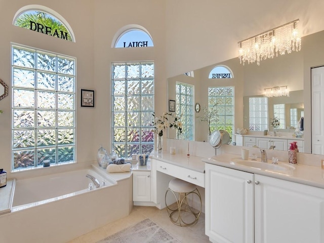 2785 Grand Isle Way SW, Vero Beach, FL 32968 - bathroom featuring a chandelier, healthy amount of natural light, a bath, tile patterned floors, and a high ceiling