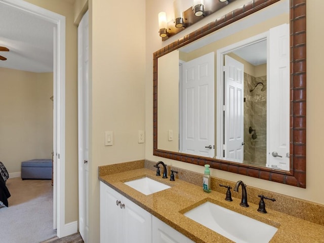 2785 Grand Isle Way SW, Vero Beach, FL 32968 - bathroom with a tile shower, double vanity, ceiling fan, and baseboards