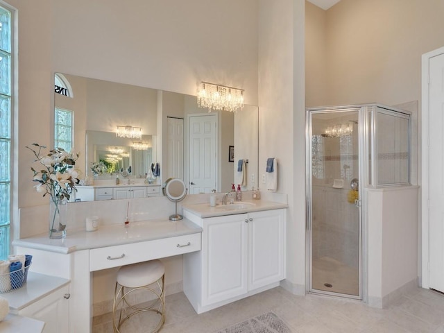 2785 Grand Isle Way SW, Vero Beach, FL 32968 - bathroom featuring a chandelier, a stall shower, tile patterned floors, vanity, and a high ceiling