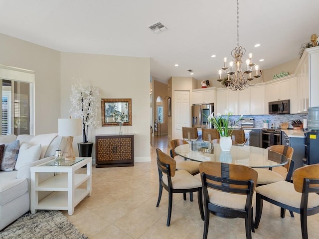 2785 Grand Isle Way SW, Vero Beach, FL 32968 - dining room featuring a chandelier, light tile patterned floors, healthy amount of natural light, and recessed lighting