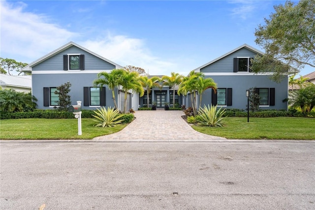 view of front of house with a front yard and french doors