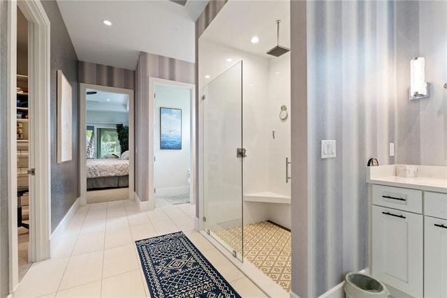 bathroom with tile patterned flooring, a shower with shower door, and vanity