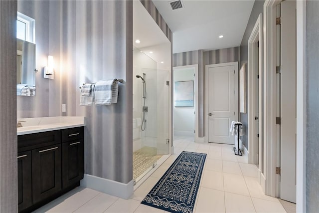 bathroom featuring a shower with shower door, tile patterned floors, and vanity