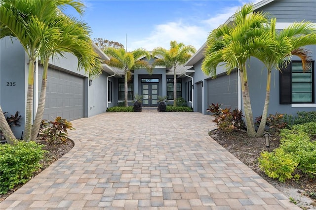 view of front facade with a garage and french doors