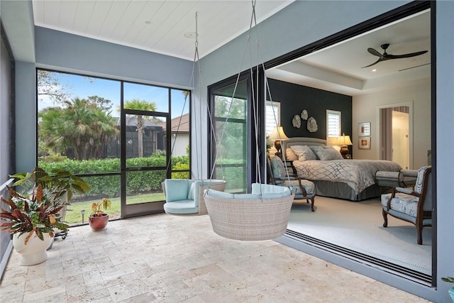 sunroom featuring ceiling fan and wooden ceiling