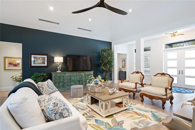 living room with light hardwood / wood-style floors and french doors