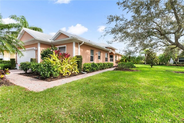 view of property exterior with a yard and an attached garage