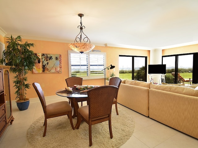 tiled dining space featuring ornamental molding