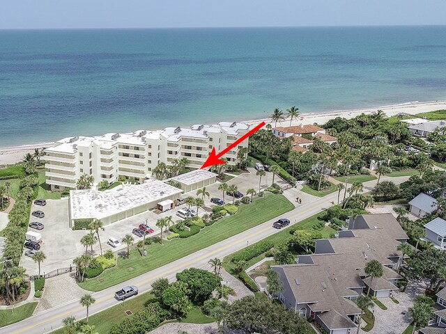 aerial view with a water view and a view of the beach