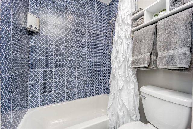 bathroom with toilet and shower / tub combo with curtain