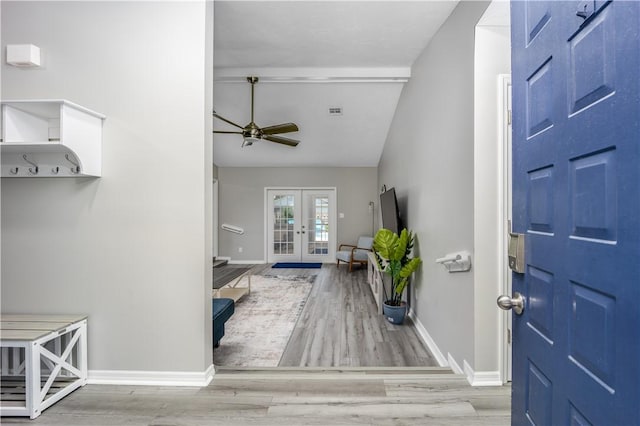 foyer with french doors, ceiling fan, baseboards, and wood finished floors