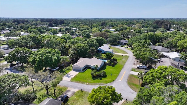 birds eye view of property with a wooded view