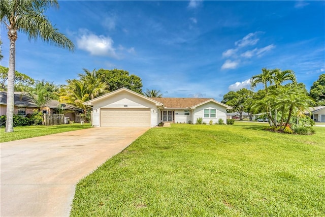 ranch-style house with an attached garage, driveway, and a front lawn