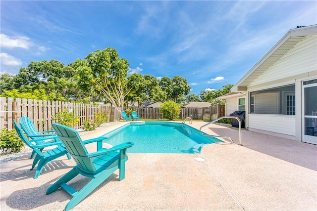 view of swimming pool featuring a patio, a fenced backyard, and a fenced in pool