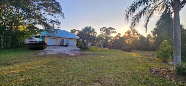 yard at dusk with a garage