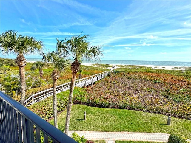 water view with fence and a view of the beach