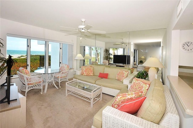 living area with ceiling fan and light colored carpet