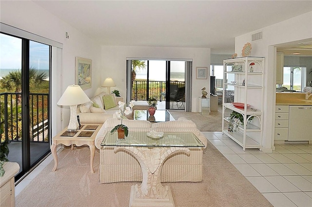 living area with visible vents and light tile patterned floors