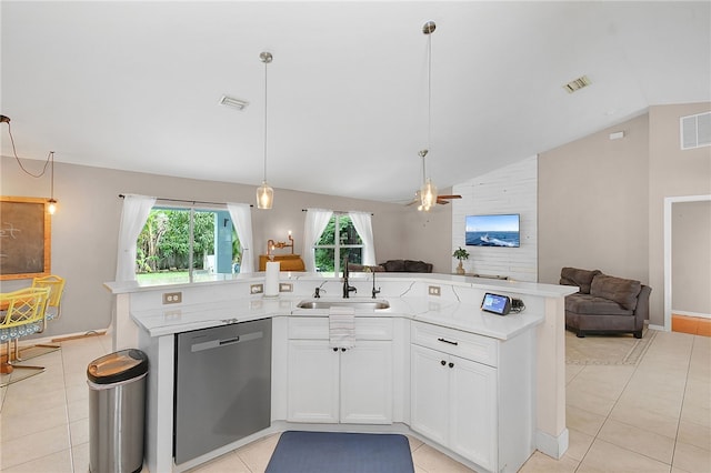 1925 Sylvester Ln, Port St Lucie, FL 34984 - kitchen with stainless steel dishwasher, open floor plan, a sink, vaulted ceiling, and light tile patterned flooring