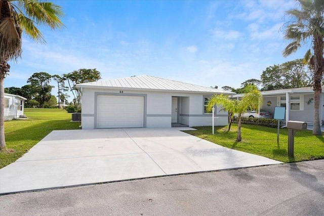 single story home featuring a front yard and a garage