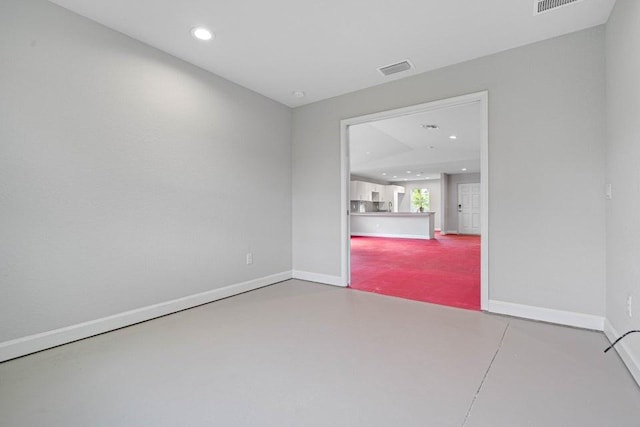 unfurnished room with concrete flooring