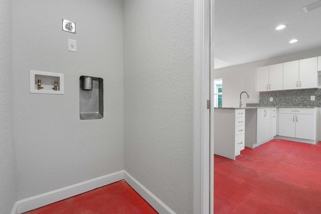 laundry area featuring cabinets, sink, and hookup for a washing machine