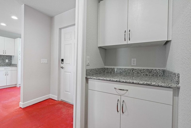 kitchen with white cabinets and stone countertops