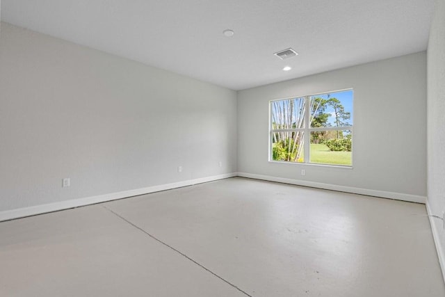 empty room with concrete flooring