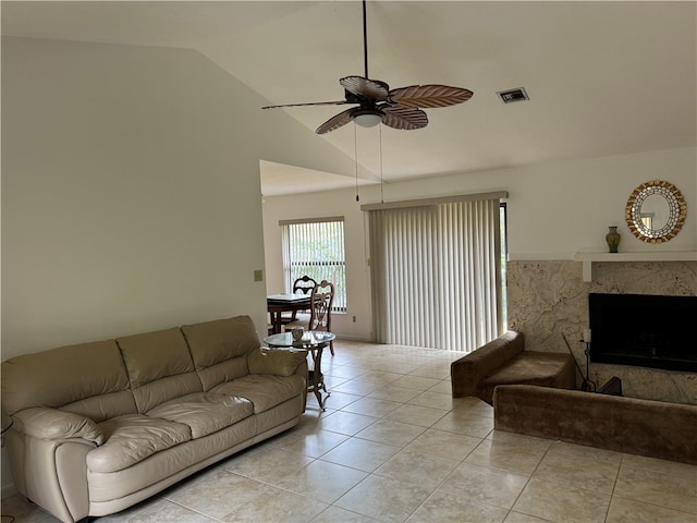 tiled living room featuring high vaulted ceiling, ceiling fan, and a high end fireplace