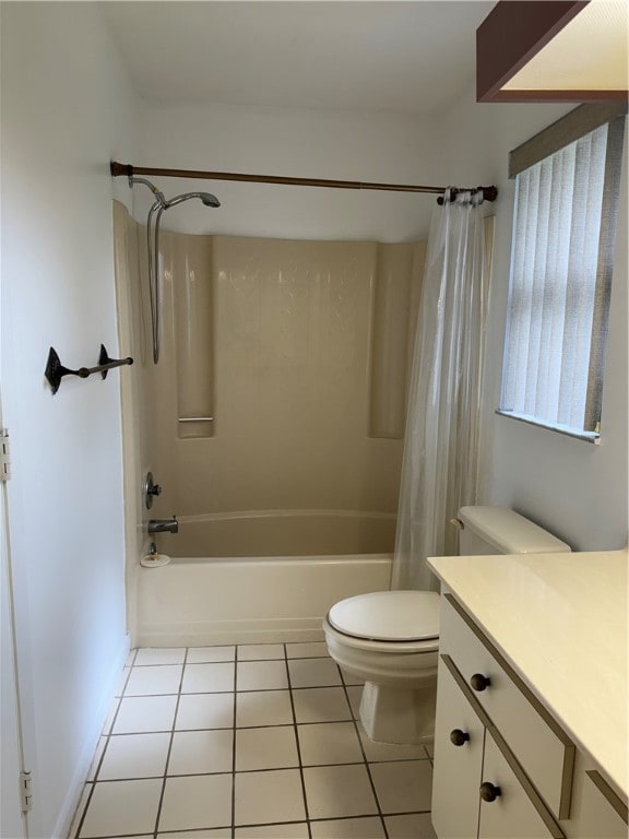 full bathroom with tile patterned floors, vanity, toilet, and shower / bath combo with shower curtain