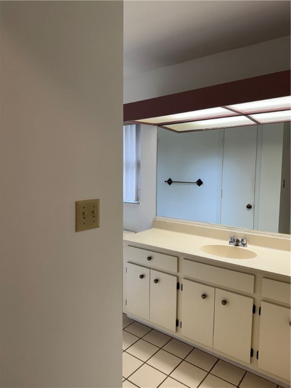 bathroom with tile patterned flooring and vanity