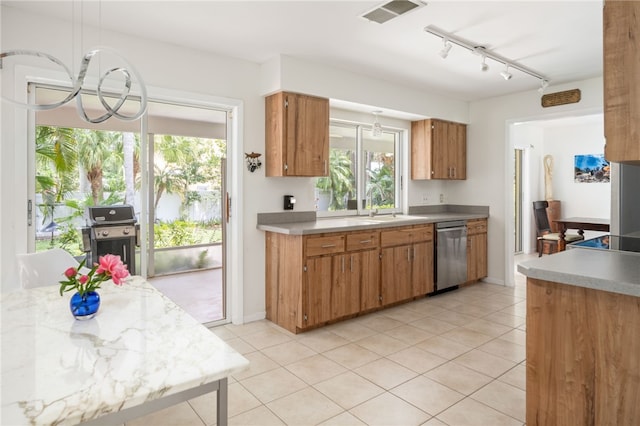 616 Broadway St, Vero Beach, FL 32960 - kitchen with dishwasher, a chandelier, a sink, light countertops, and brown cabinets